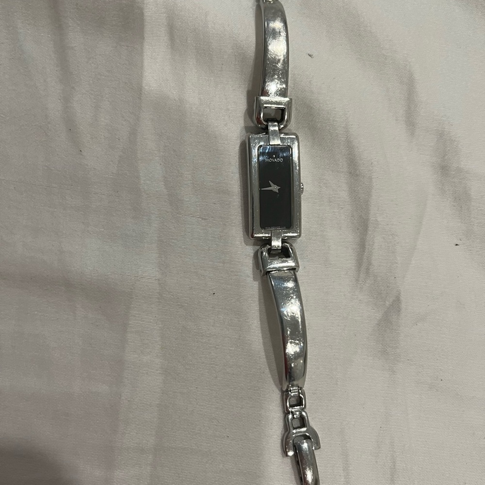 Women’s silver Movado watch with black face